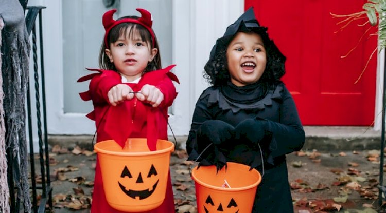 Two girls wearing costumes.
